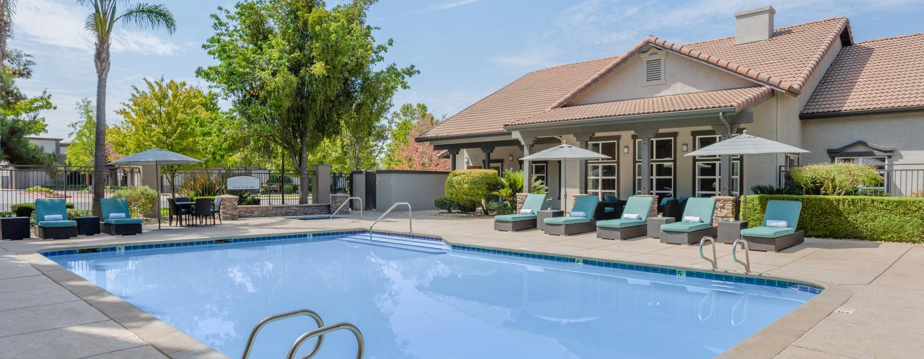 a swimming pool with chairs around it