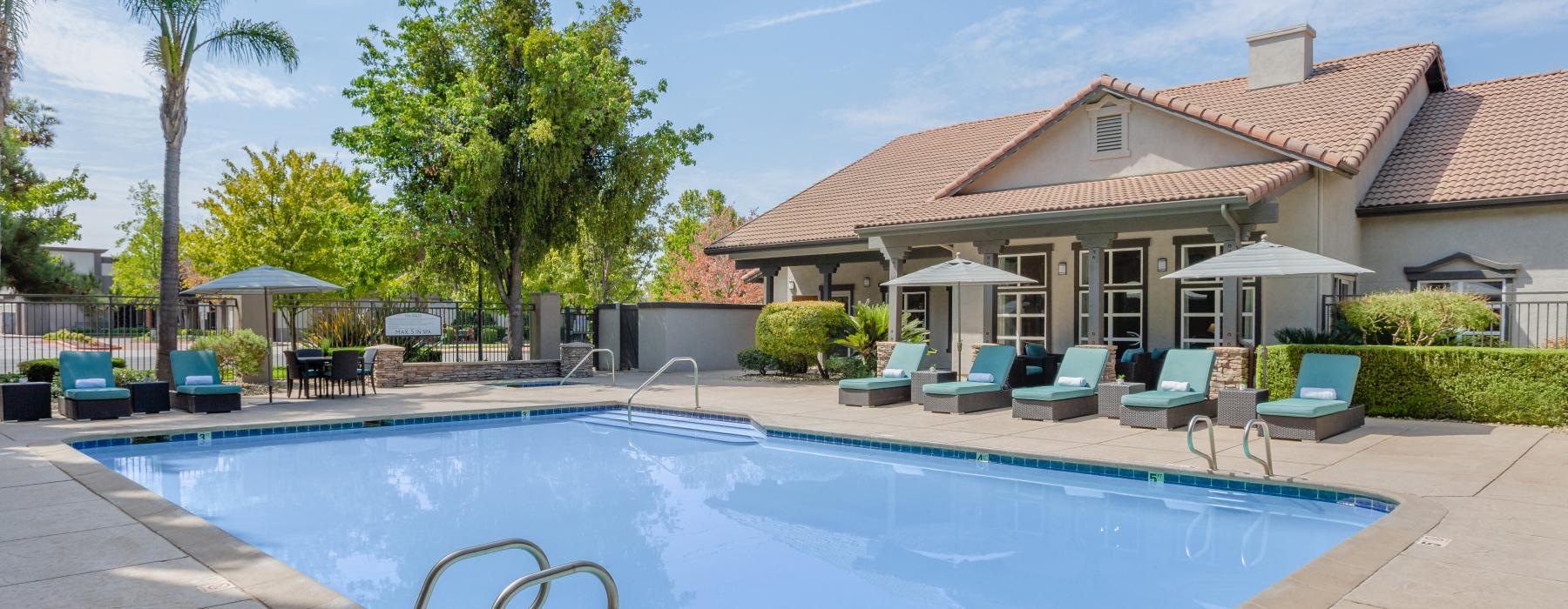 a swimming pool with chairs around it