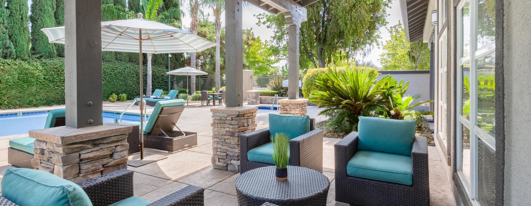 a patio with chairs and umbrellas