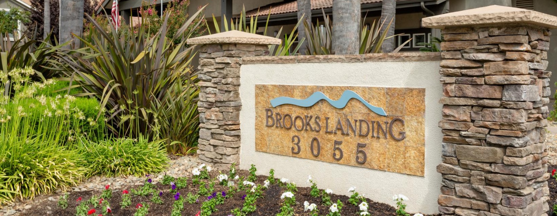 a sign on a stone wall