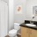 a bathroom with a sink toilet and mirror